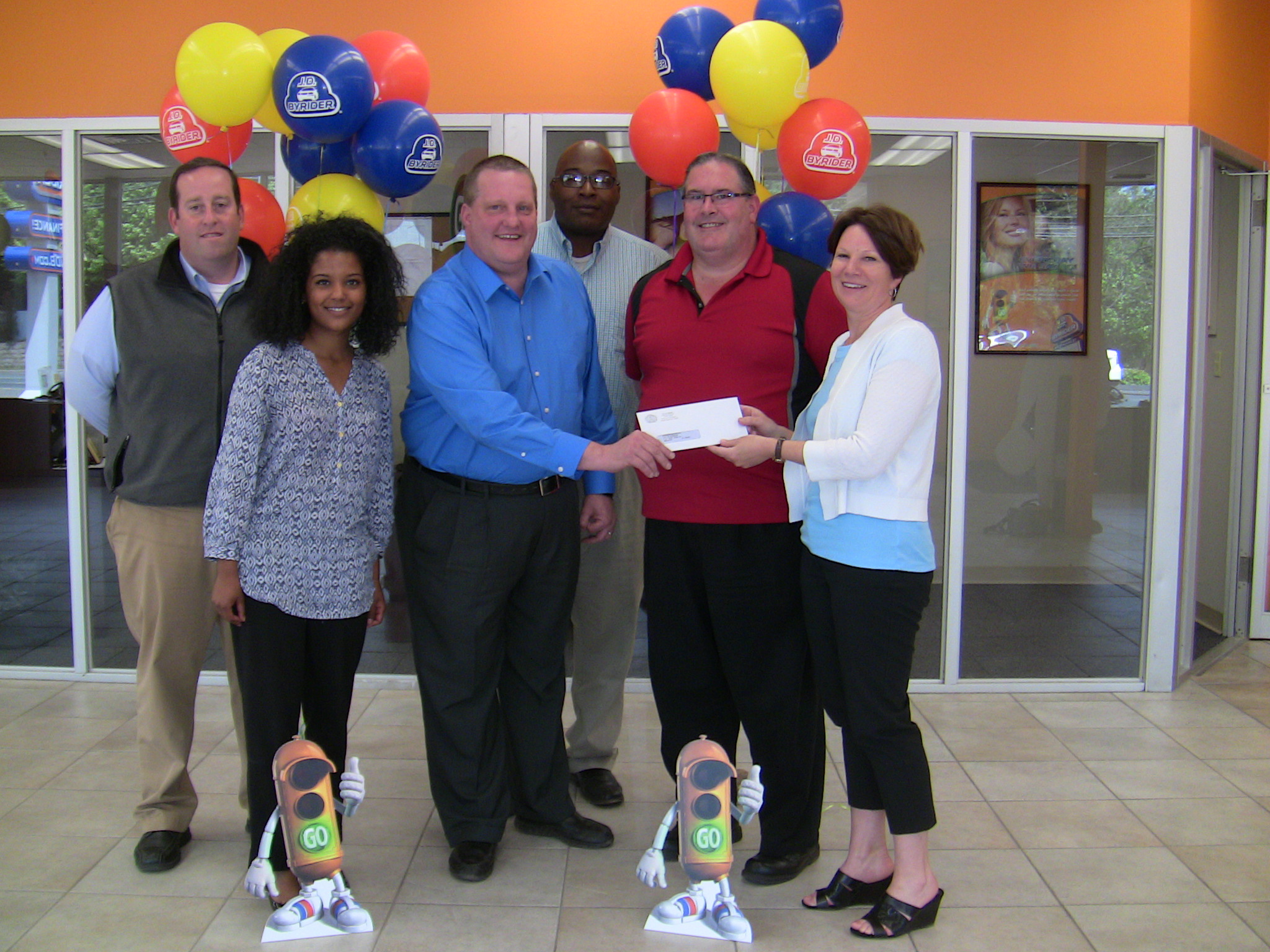Staff of JD Byrider accepting a check